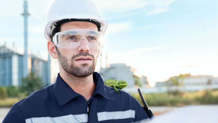 worker with helmet in front of power plant