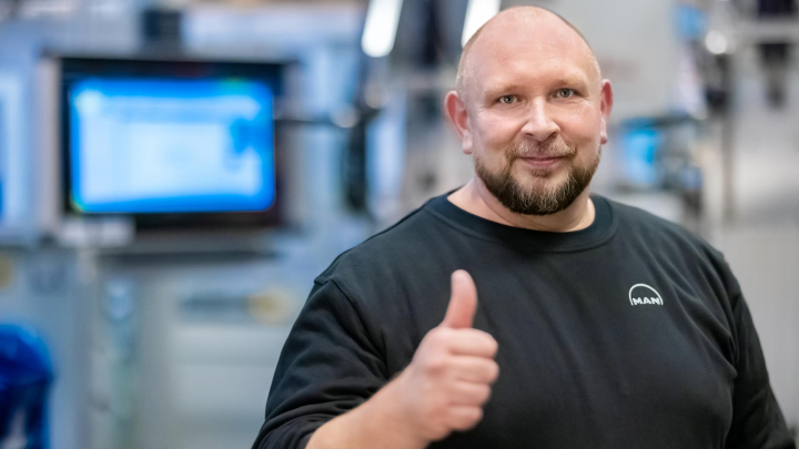 production employee gives thumbs up