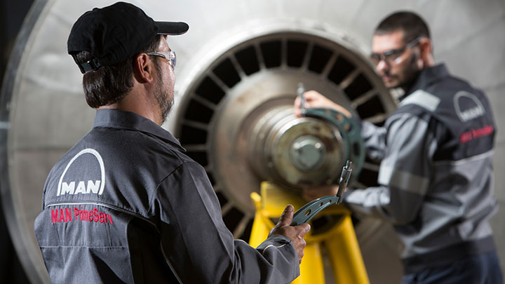 Two service engineers checking a turbine