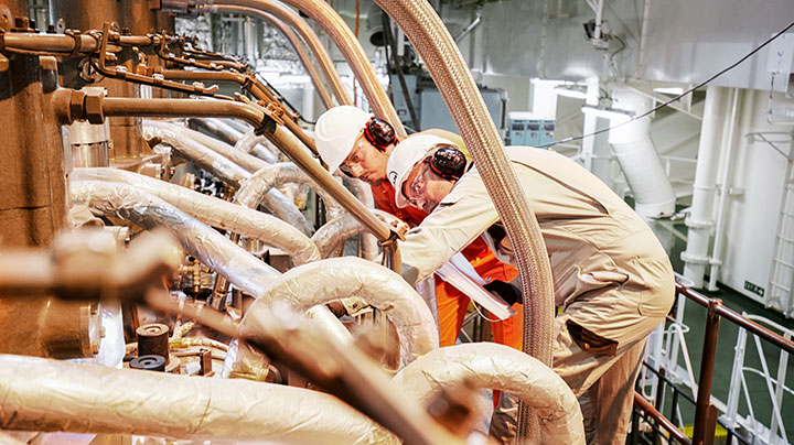 MAN PrimeServ engineers working on a two-stroke engine