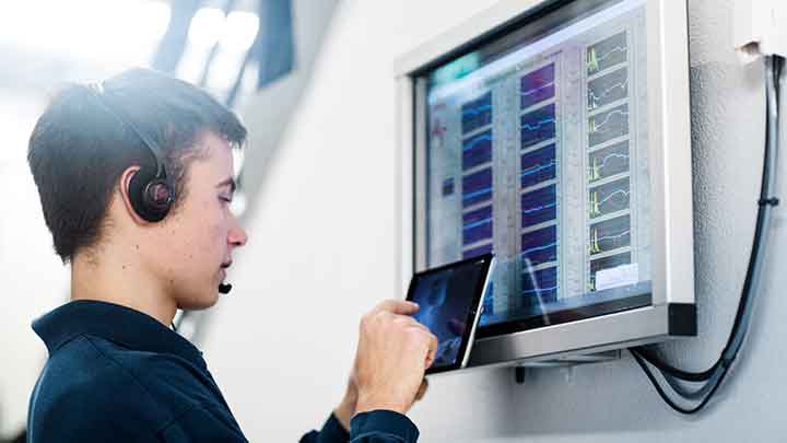 Young man with headset at display